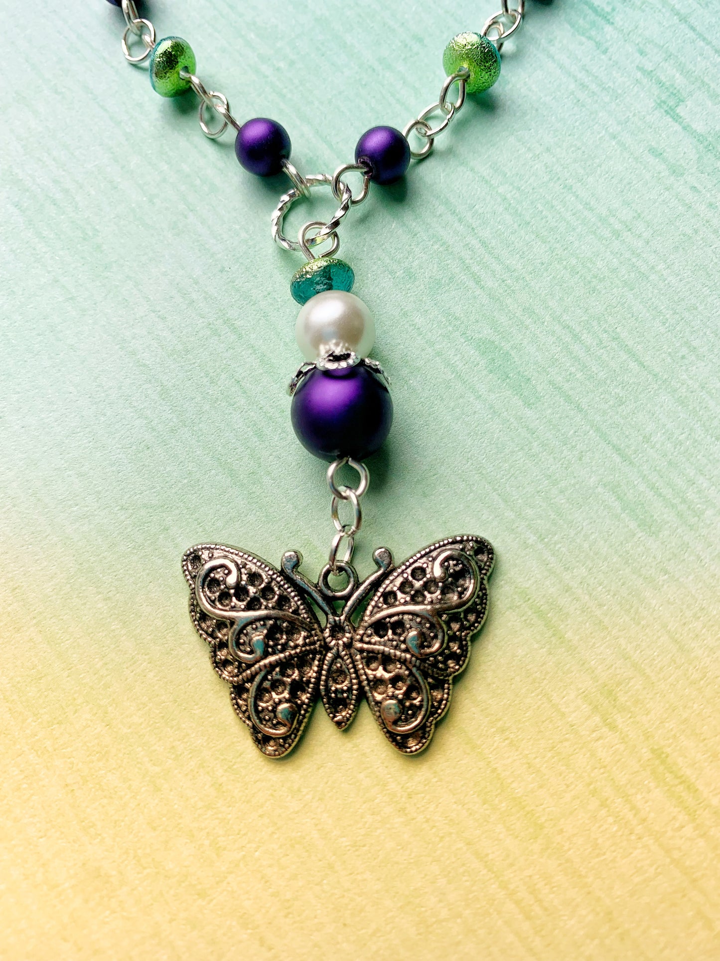 Purple and White Glass Pearl Chain Link Necklace with Green and Aqua Glass Etched Rondelle Beads and a Fancy Silver Metal Butterfly Charm Pendant