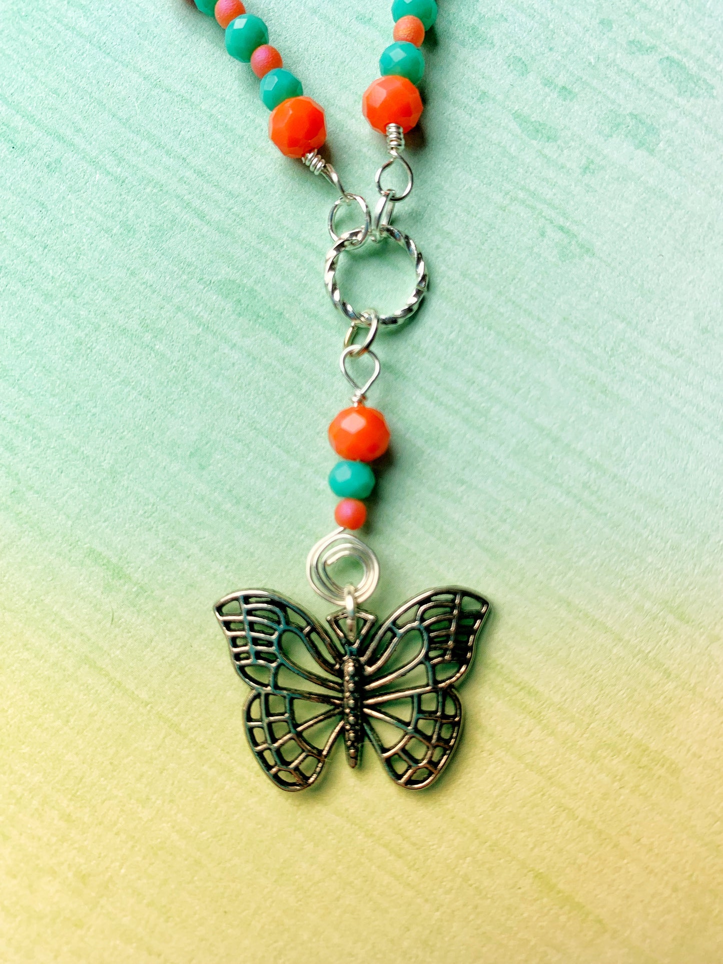 Dainty Orange and Green Glass Rondelle Necklace with a Simple Antique Silver Metal Butterfly Charm Pendant