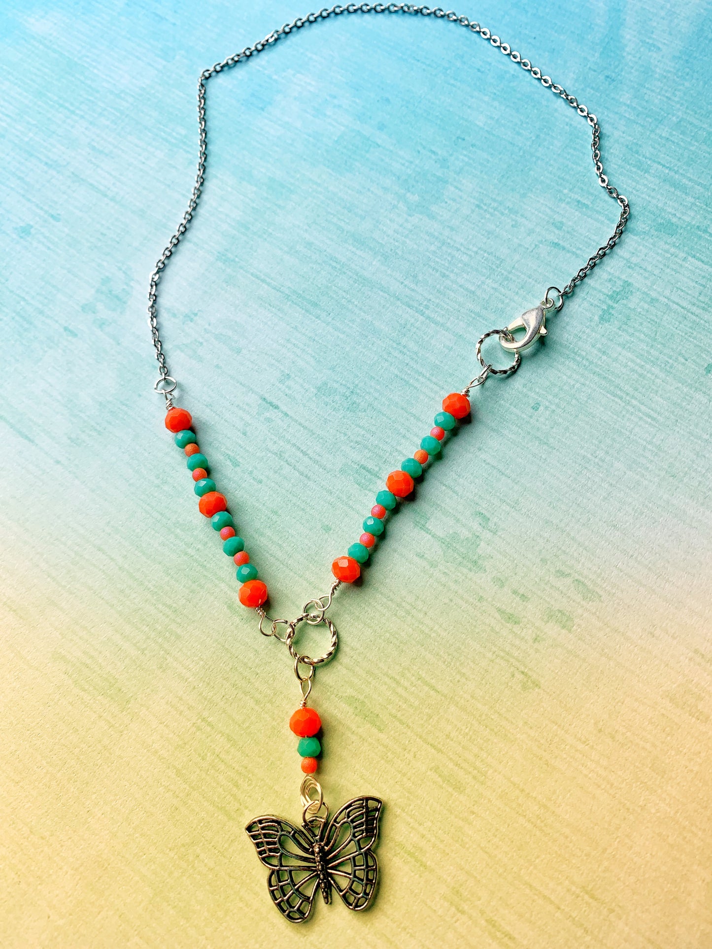 Dainty Orange and Green Glass Rondelle Necklace with a Simple Antique Silver Metal Butterfly Charm Pendant