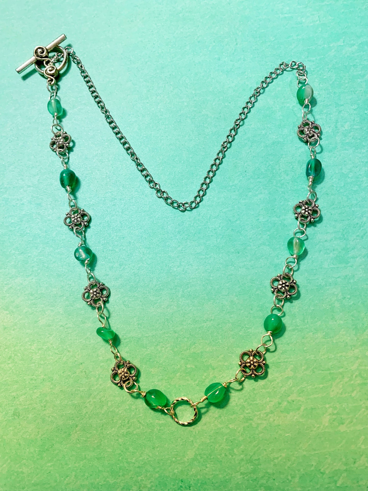 Green Pebble Gemstone and Silver Charm Link Necklace with Swirl Toggle