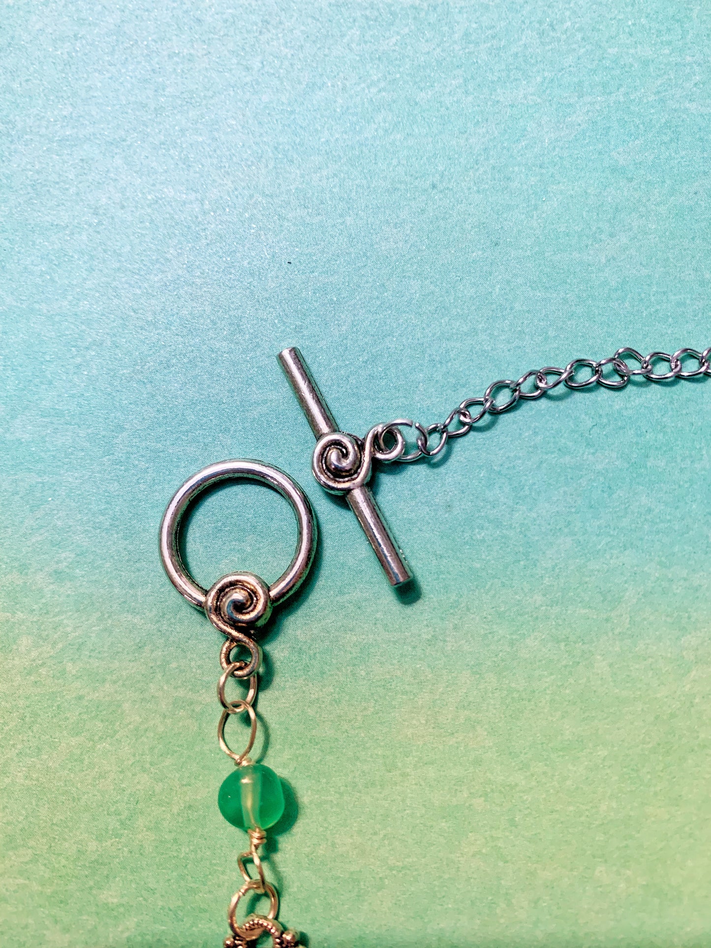 Green Pebble Gemstone and Silver Charm Link Necklace with Swirl Toggle