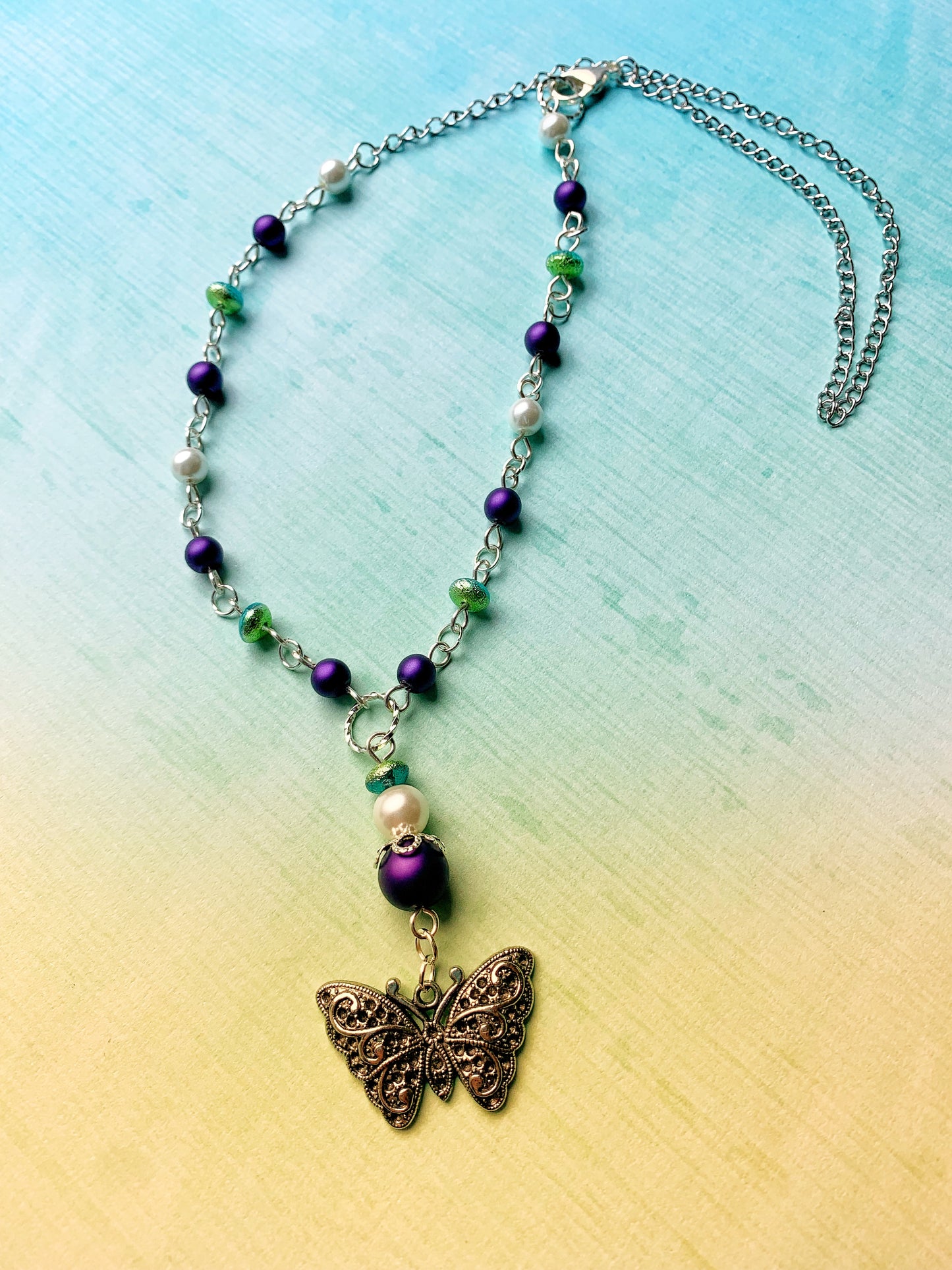 Purple and White Glass Pearl Chain Link Necklace with Green and Aqua Glass Etched Rondelle Beads and a Fancy Silver Metal Butterfly Charm Pendant