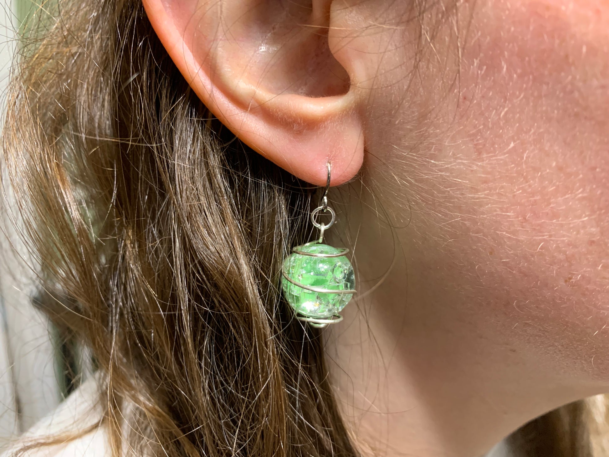 Green wire-wrapped cracked marble earring model shot